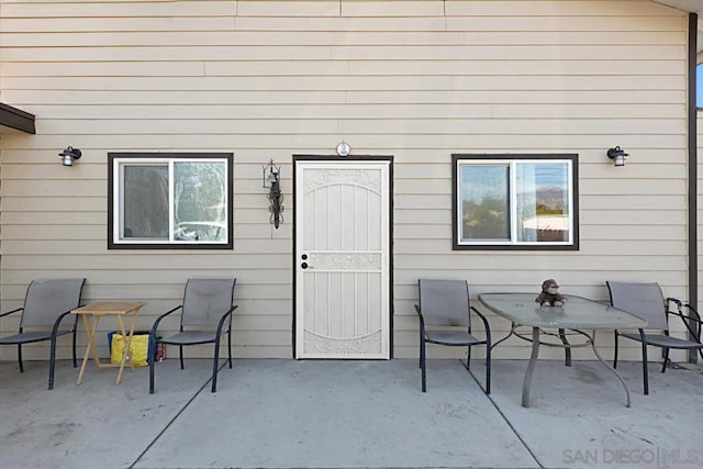 doorway to property with a patio