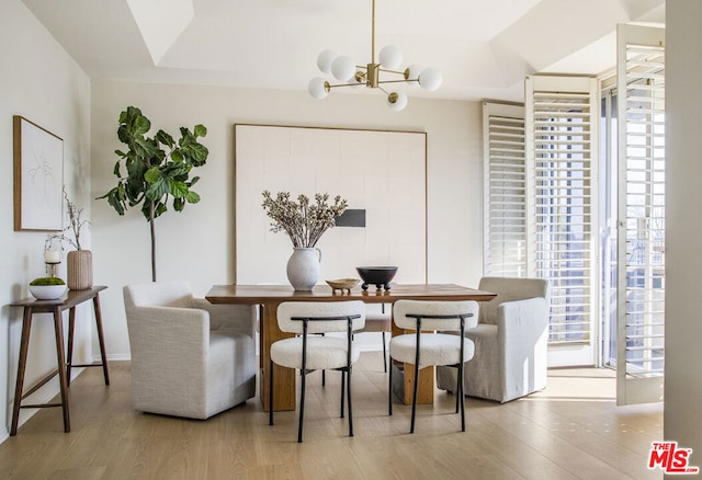 dining room featuring light hardwood / wood-style floors and a notable chandelier