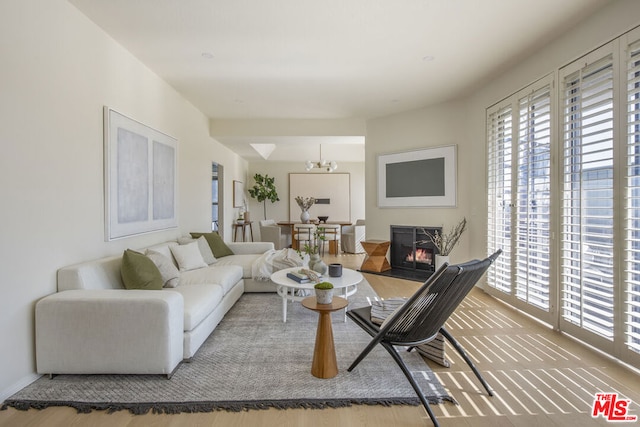 living room with an inviting chandelier and hardwood / wood-style floors