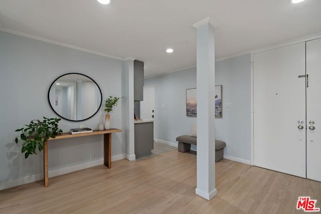 entryway featuring light hardwood / wood-style flooring and ornamental molding