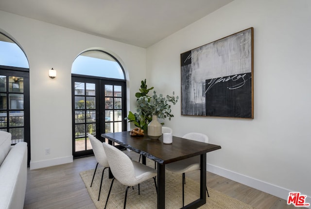 dining area featuring light hardwood / wood-style flooring and french doors