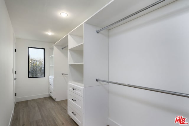 walk in closet featuring light hardwood / wood-style flooring