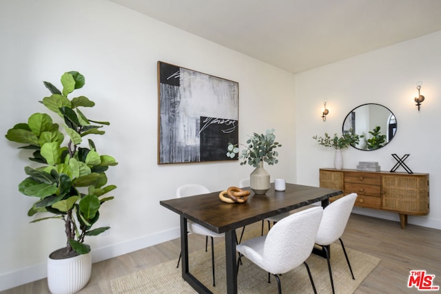 dining area with hardwood / wood-style flooring