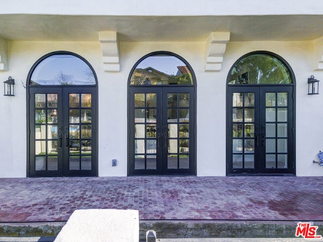 entrance to property with a patio area and french doors