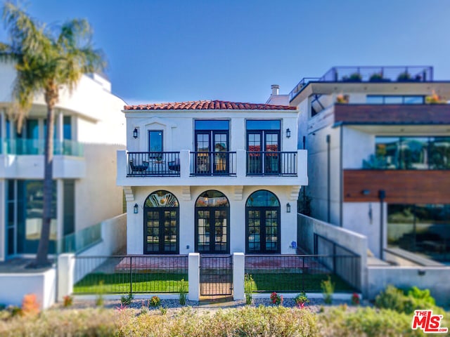 view of front of house featuring french doors and a balcony