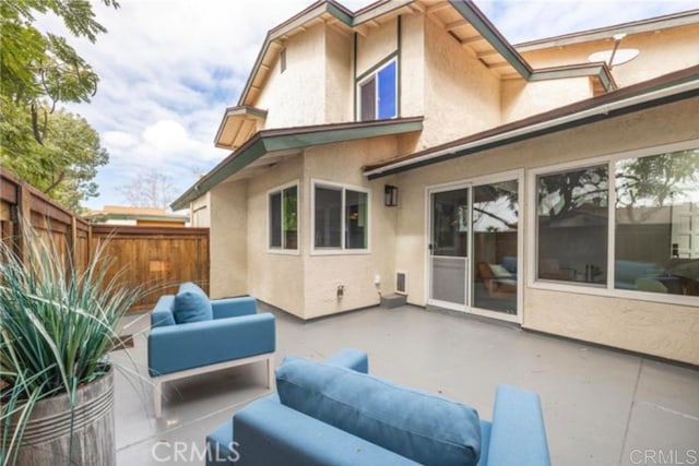 rear view of house featuring outdoor lounge area and a patio area