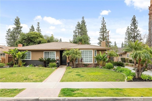 ranch-style home featuring a front lawn