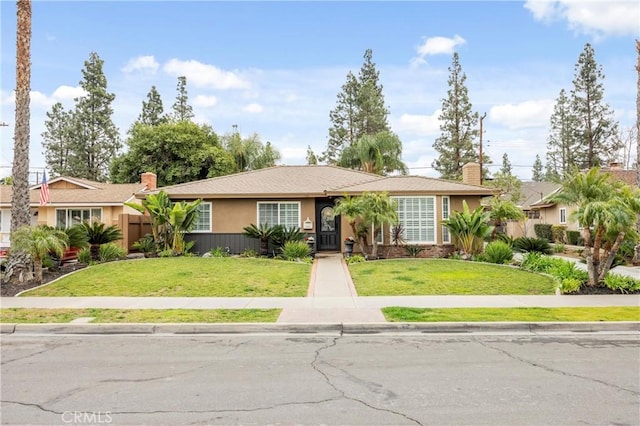 ranch-style house featuring a front lawn