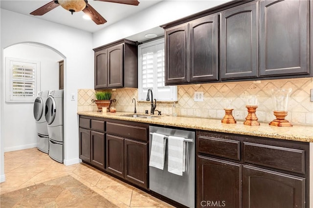 kitchen with washing machine and clothes dryer, sink, tasteful backsplash, dark brown cabinets, and dishwasher