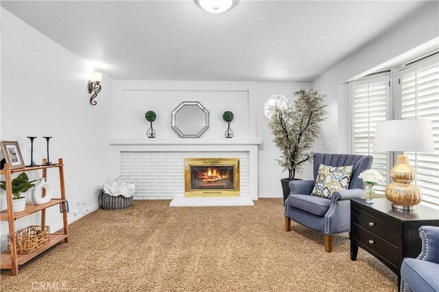 living area with a fireplace and carpet flooring