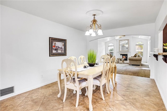 tiled dining area featuring a notable chandelier