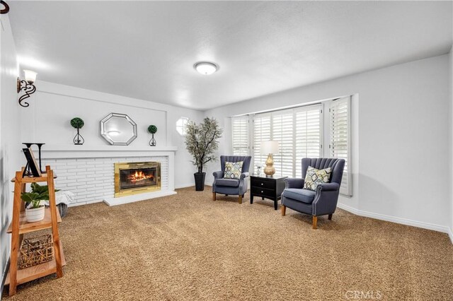 living area featuring a fireplace and carpet flooring