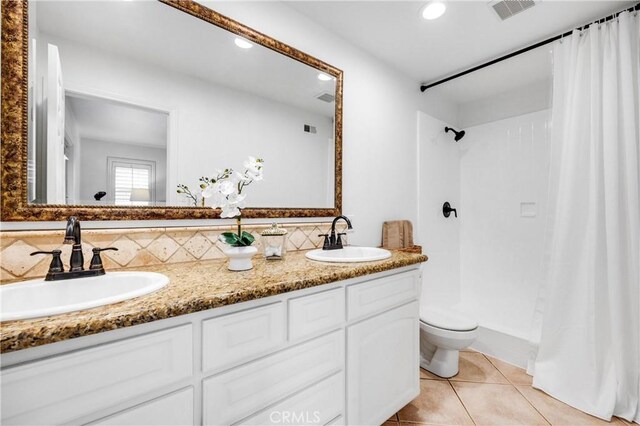 bathroom featuring tile patterned floors, toilet, vanity, curtained shower, and backsplash