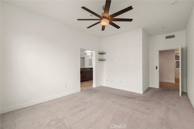 spare room featuring ceiling fan and light colored carpet