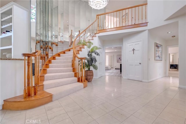 entrance foyer featuring a high ceiling and a notable chandelier