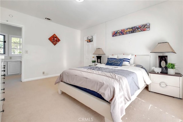 bedroom featuring light colored carpet