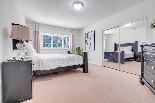 carpeted bedroom with a closet