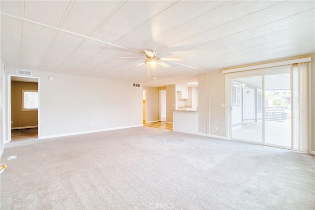 carpeted spare room featuring ceiling fan