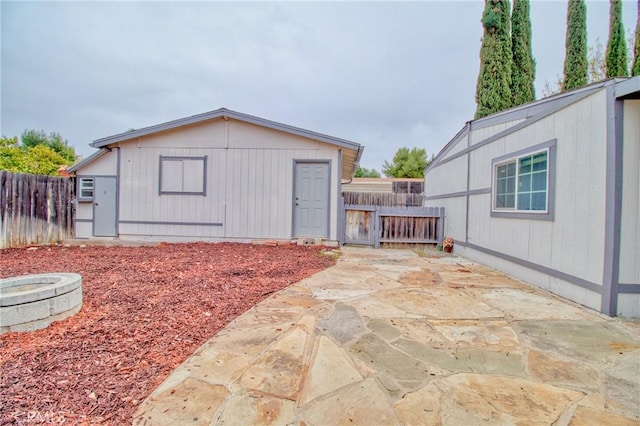 view of outbuilding featuring an outdoor fire pit