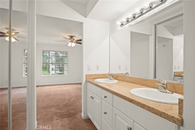 full bathroom featuring double vanity, baseboards, a ceiling fan, and a sink