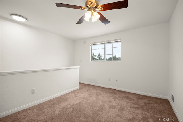 unfurnished room featuring light carpet, ceiling fan, visible vents, and baseboards