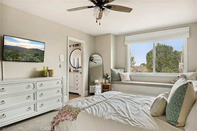 bedroom featuring ceiling fan and connected bathroom