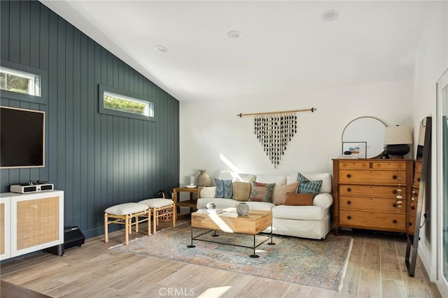 living room featuring vaulted ceiling and light hardwood / wood-style floors