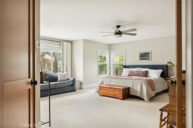 bedroom featuring multiple windows, carpet flooring, and ceiling fan