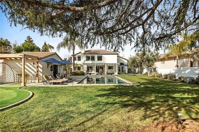 rear view of house with a lawn, a patio area, and a pergola