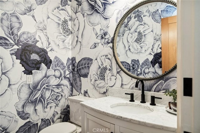 bathroom featuring vanity and toilet