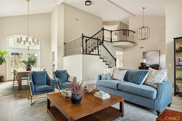 living room featuring a notable chandelier, wood-type flooring, high vaulted ceiling, and beamed ceiling