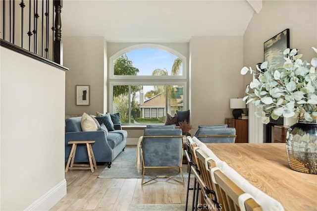 living room featuring light hardwood / wood-style flooring and a high ceiling