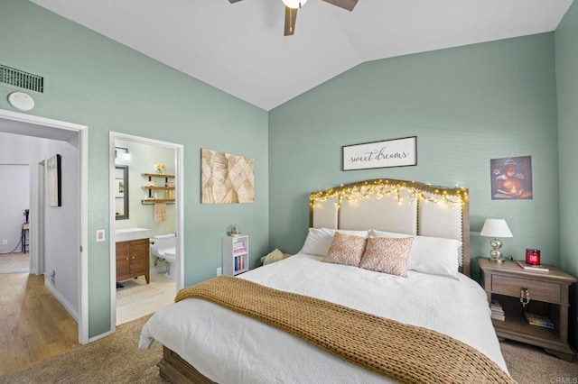 bedroom with vaulted ceiling, connected bathroom, and ceiling fan