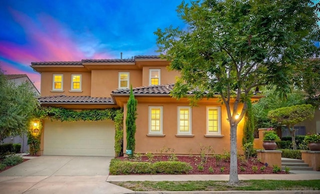 mediterranean / spanish-style house featuring a garage