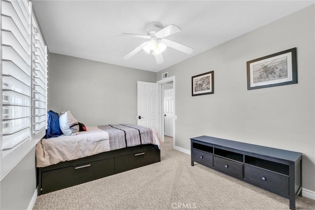 bedroom featuring light colored carpet and ceiling fan