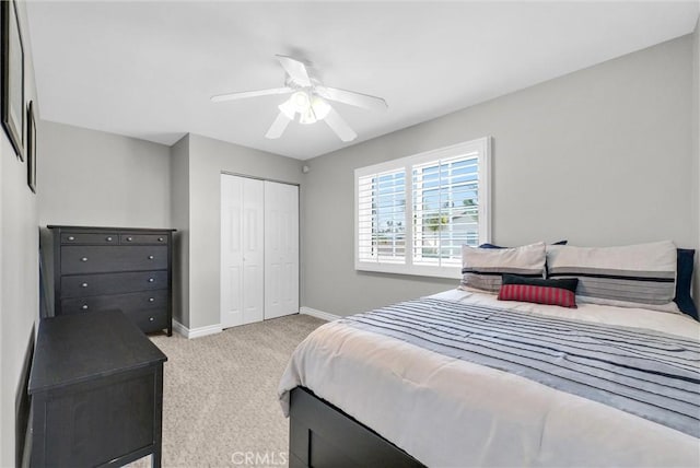 bedroom featuring light carpet and ceiling fan