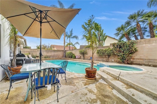 view of pool featuring a patio area and an in ground hot tub