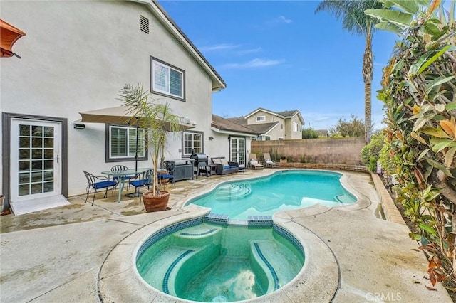 view of pool with a patio area and an in ground hot tub