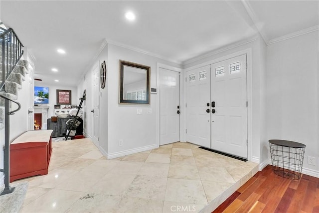 entryway featuring light tile patterned floors and ornamental molding