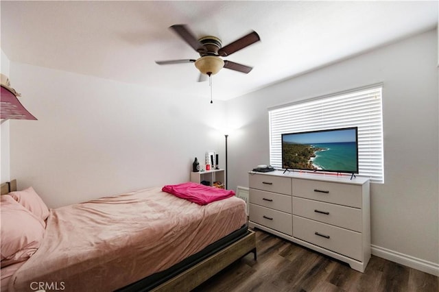 bedroom with ceiling fan and dark hardwood / wood-style floors