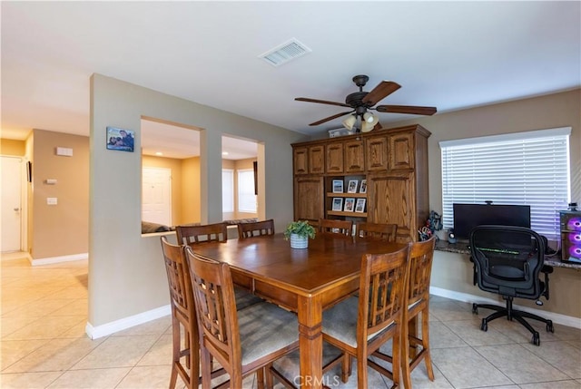 tiled dining space with ceiling fan