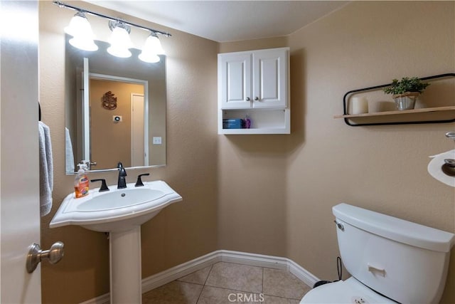 bathroom with tile patterned floors and toilet