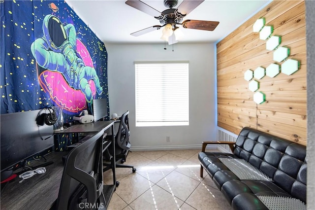 home office with tile patterned flooring, wooden walls, and ceiling fan