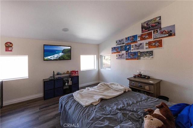 bedroom featuring dark wood-type flooring and lofted ceiling