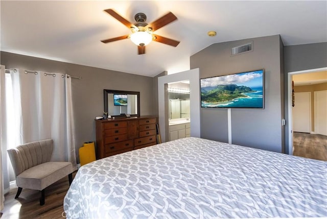 bedroom with ensuite bathroom, lofted ceiling, dark hardwood / wood-style floors, and ceiling fan