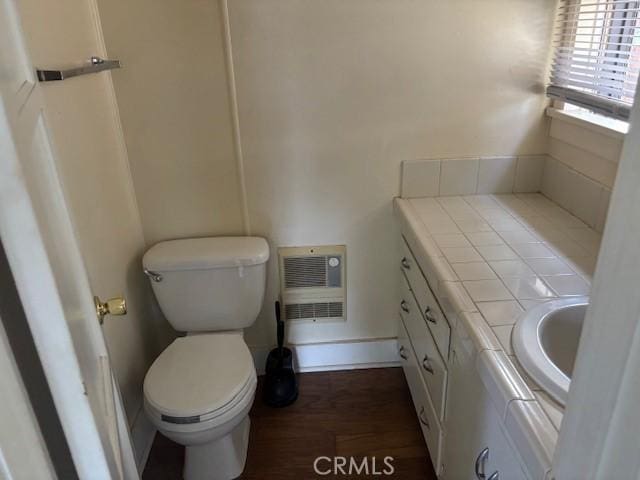 bathroom with vanity, wood-type flooring, and toilet