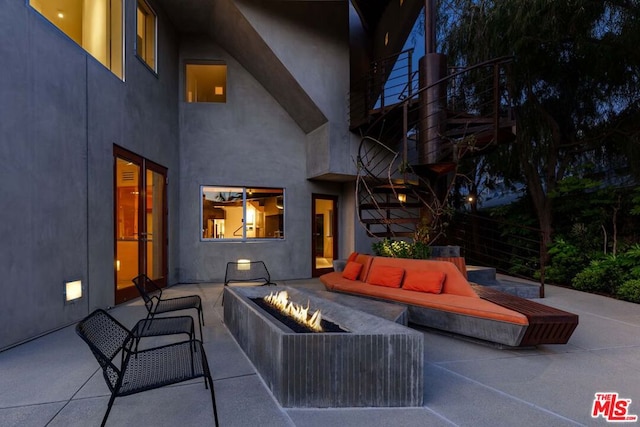 view of patio / terrace with an outdoor living space with a fire pit