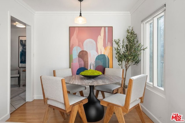 dining room featuring hardwood / wood-style floors and ornamental molding