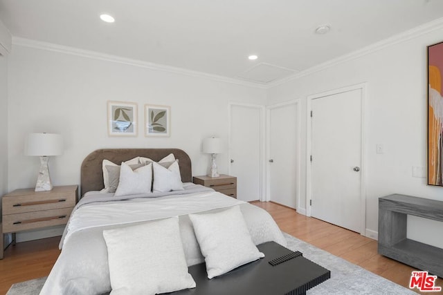 bedroom with crown molding and light wood-type flooring