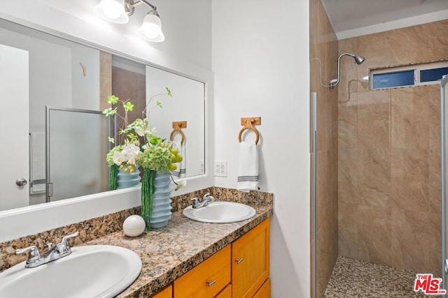 bathroom featuring vanity and tiled shower